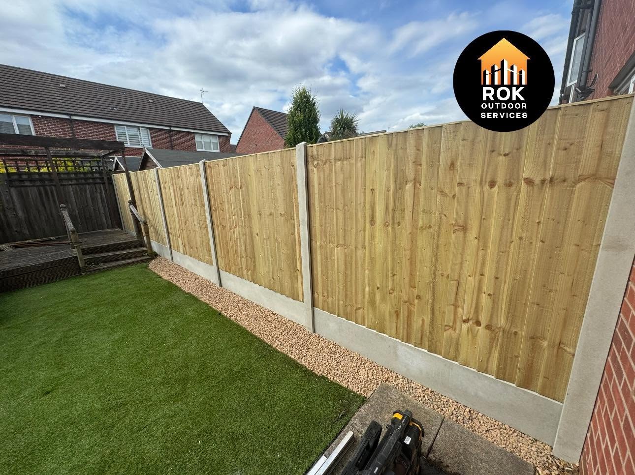 New timber fence with concrete posts alongside a lawn