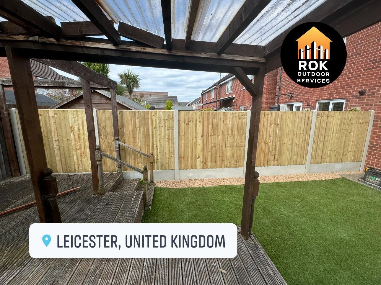 Finished new fence beside a pergola and garden lawn