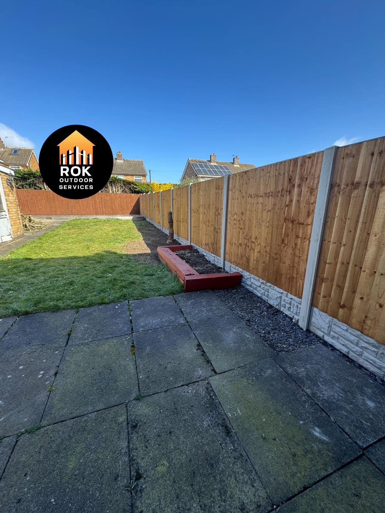 Timber fencing along a garden patio and lawn
